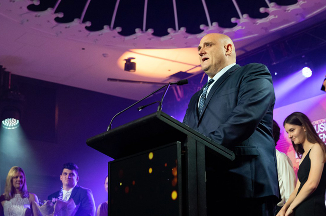 Company representative presenting on solar lighting innovation at industry conference