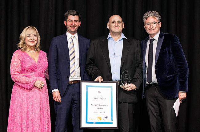 Company representative receiving award at industry or community recognition event