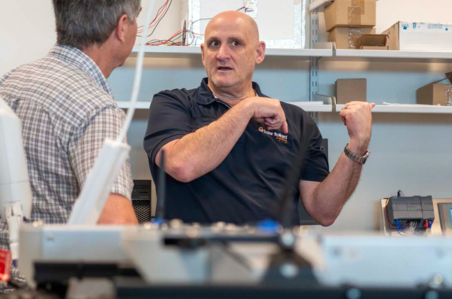 Solar lighting expert discussing product development and innovation with industry partner