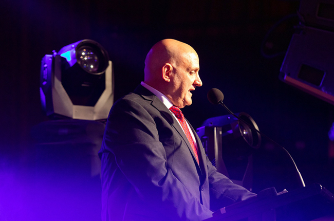 Company representative presenting at industry or community event on stage