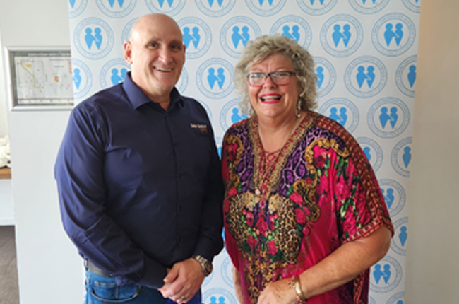 Solar Bollard Lighting team member with community partner at charity event