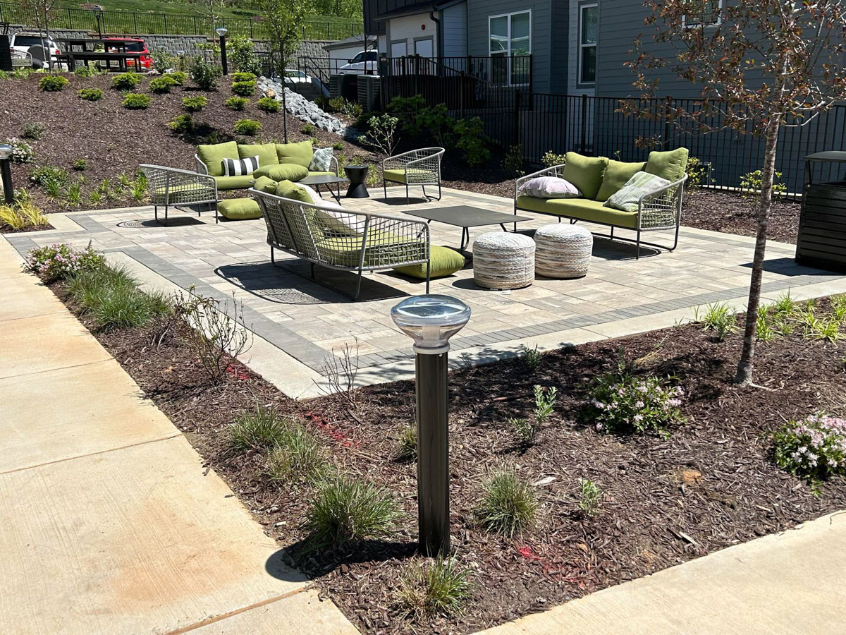 Solar pathway bollard lighting along landscaped walkway at Axis at the Park apartment complex North Carolina